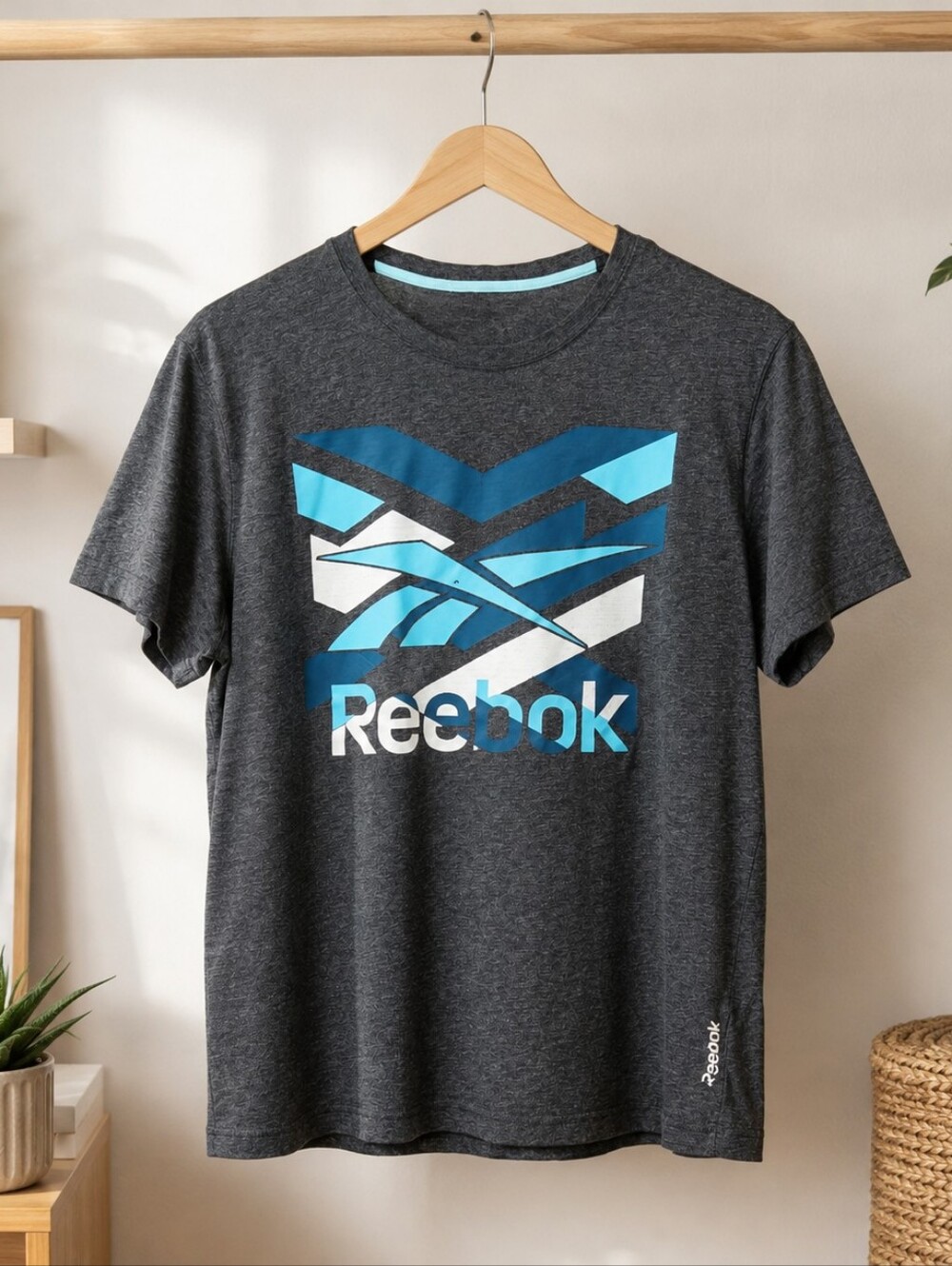 Reebok charcoal gray graphic tee with a huge blue / aqua / white classic Vector